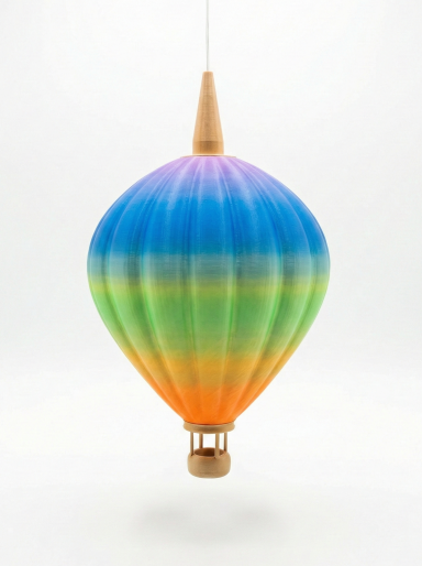 Bunte Heißluftballon-Dekoration mit Farbverlauf von Blau über Orange bis Rot.