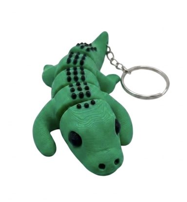 Grüner Krokodil-Schlüsselanhänger mit schwarzen Punkten und beweglichen Gliedern.